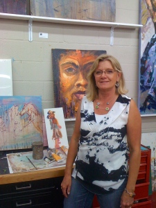 Faye standing in front of some of her pieces.